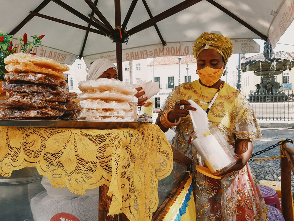 a Baiana de Acarajé at work in Praça da Sé, a square located in the historic center of Salvador