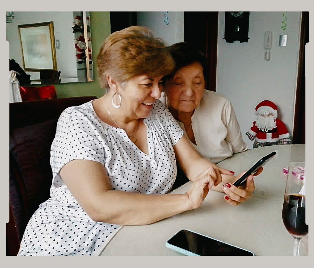 Troubleshooting a cell phone with her aunt, whom she cares for in addition to her parents